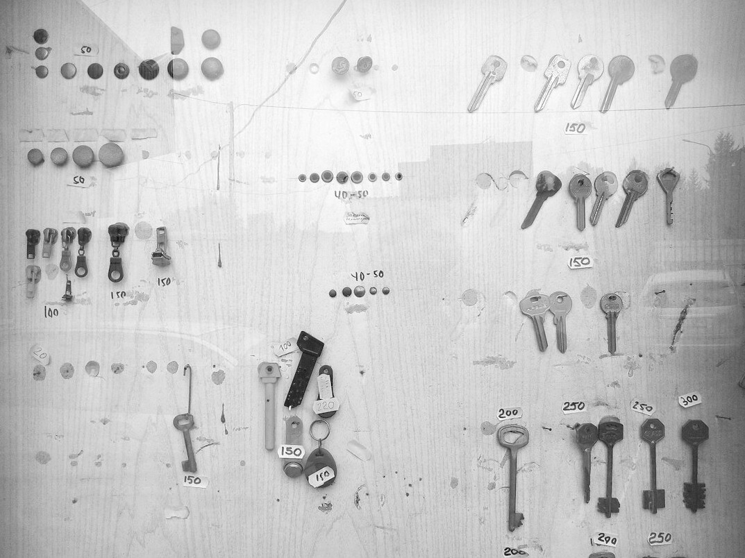 Top down flat lay of apartment keys, blueprints and coffee